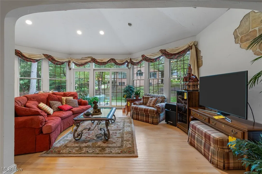 Great room with recessed lighting, light wood-style floors, and vaulted ceiling
