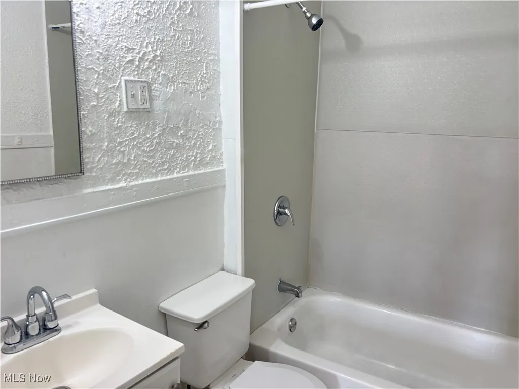 Full bathroom featuring vanity and washtub / shower combination