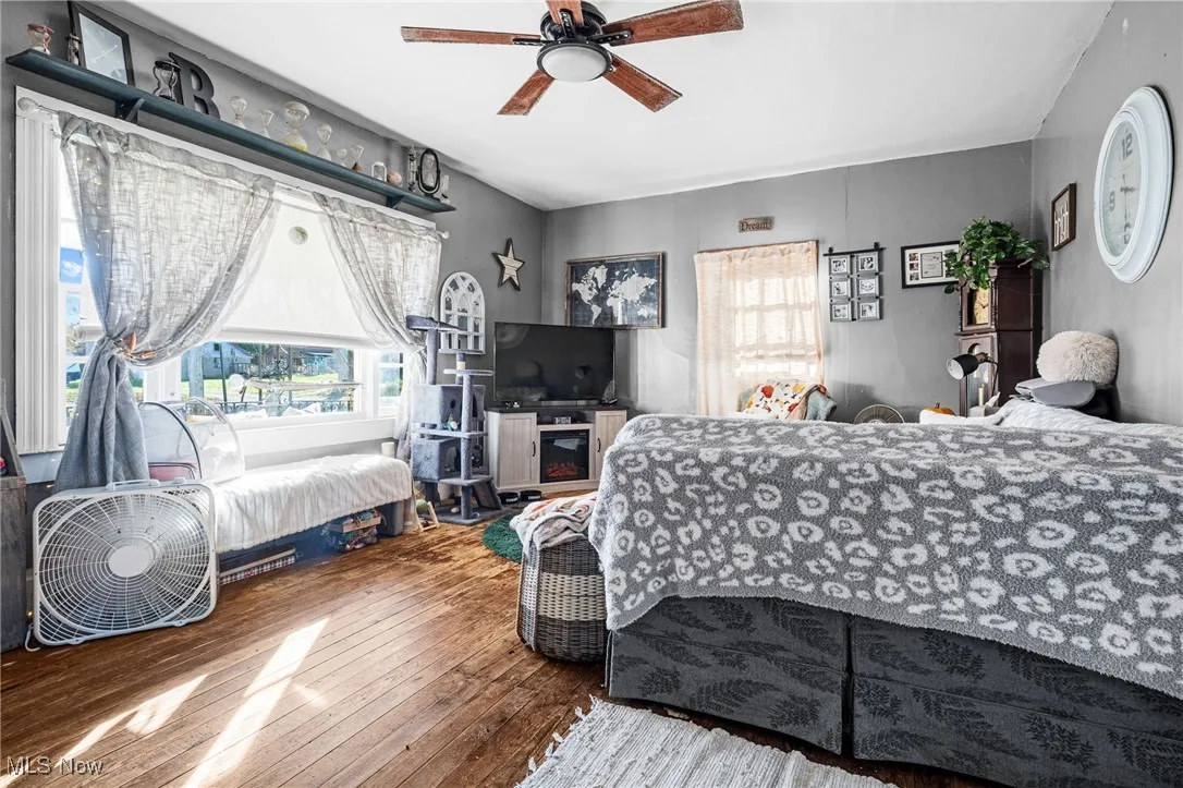 Bedroom with hardwood / wood-style flooring and a ceiling fan