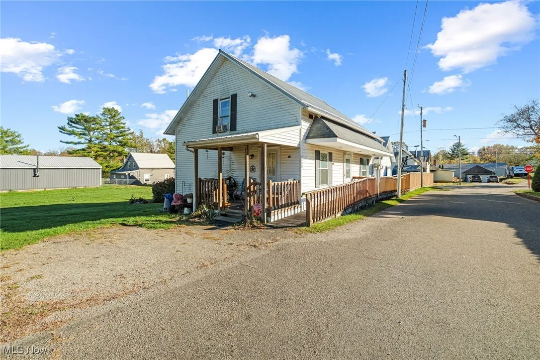 View of front of house featuring covered porch and a front yard