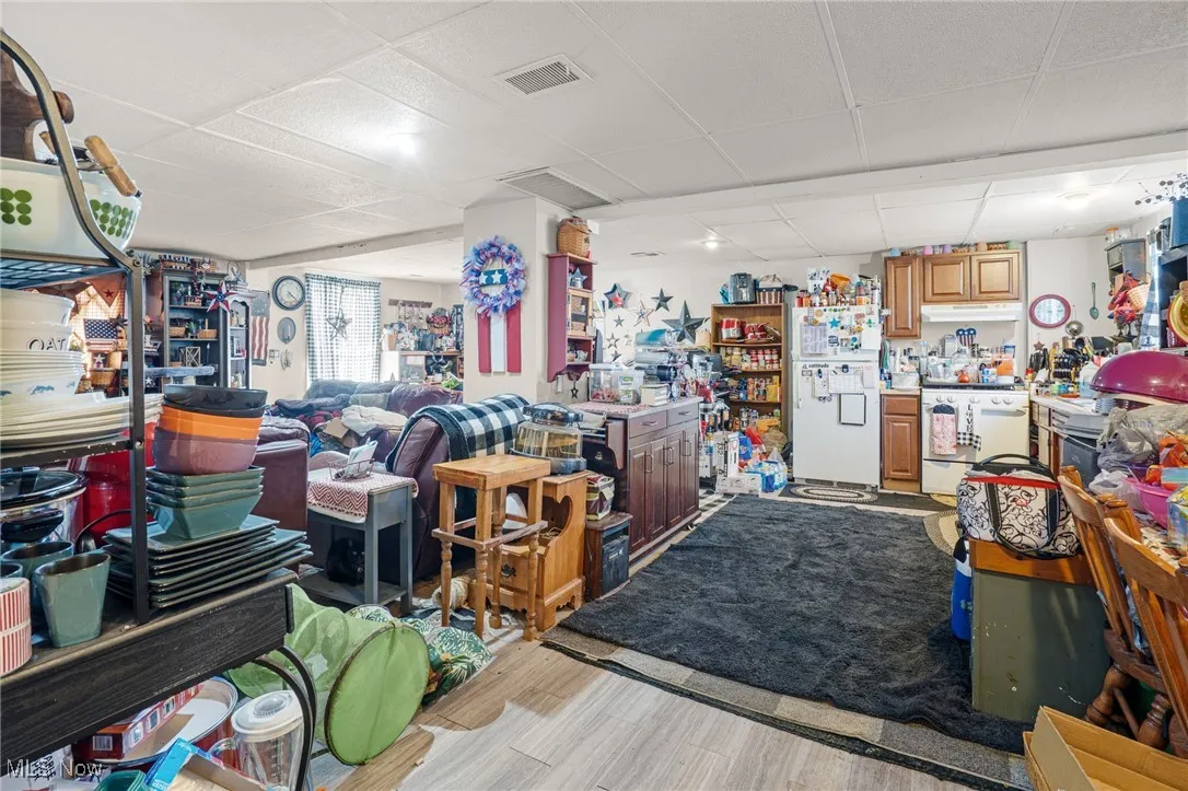 Misc room featuring a drop ceiling and light wood-style flooring