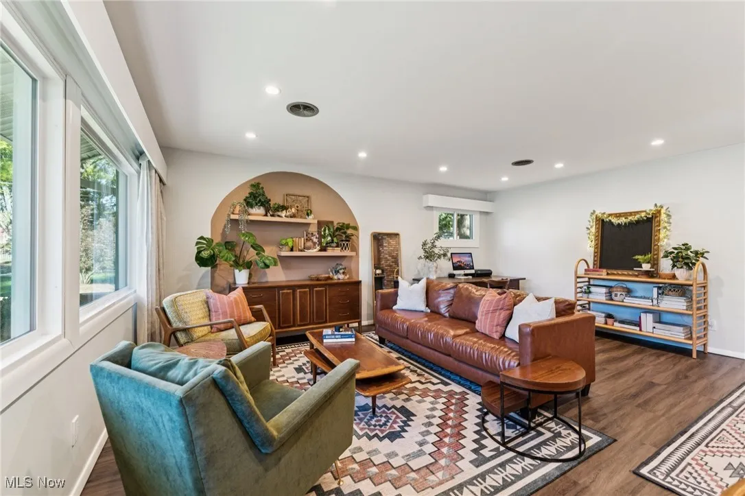 Living area with dark wood-style flooring and recessed lighting