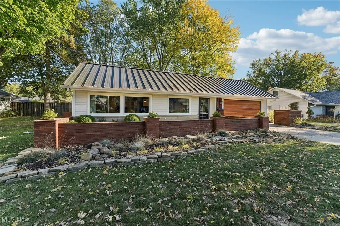 Ranch-style house with a metal roof and a standing seam roof