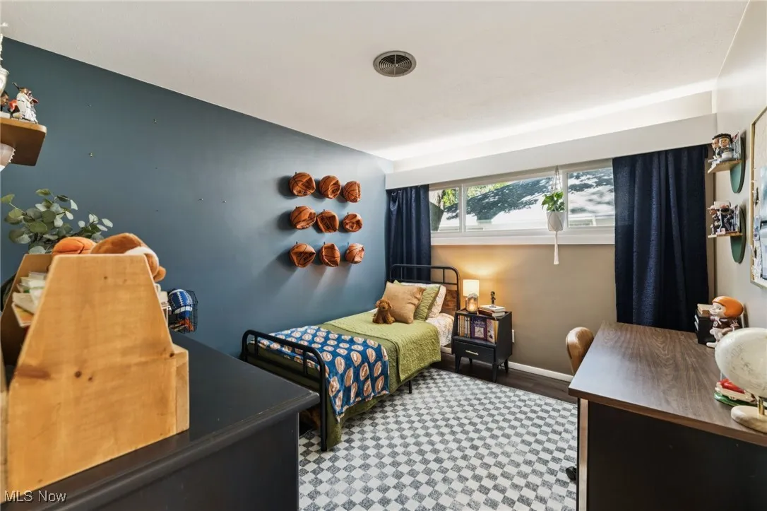 Bedroom featuring baseboards and wood finished floors