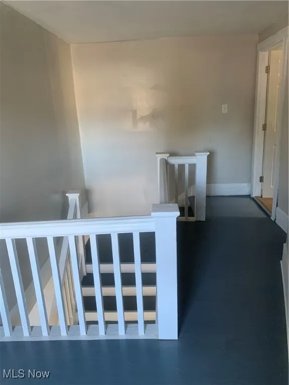 Staircase featuring baseboards