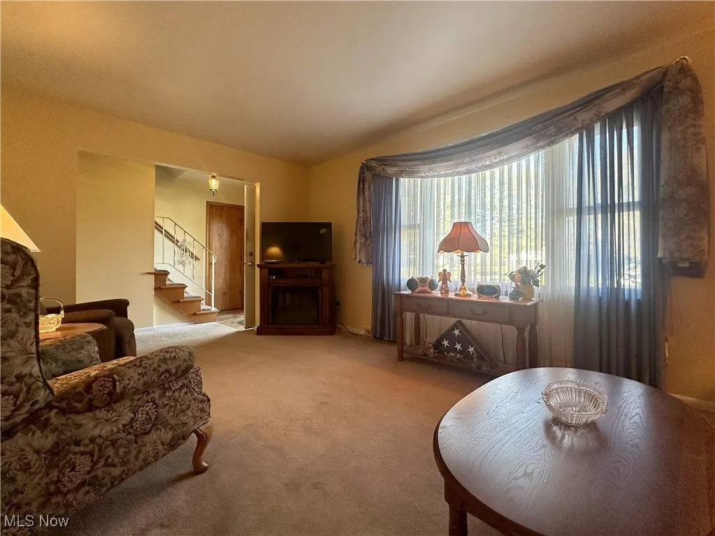 Living room with carpet and stairs