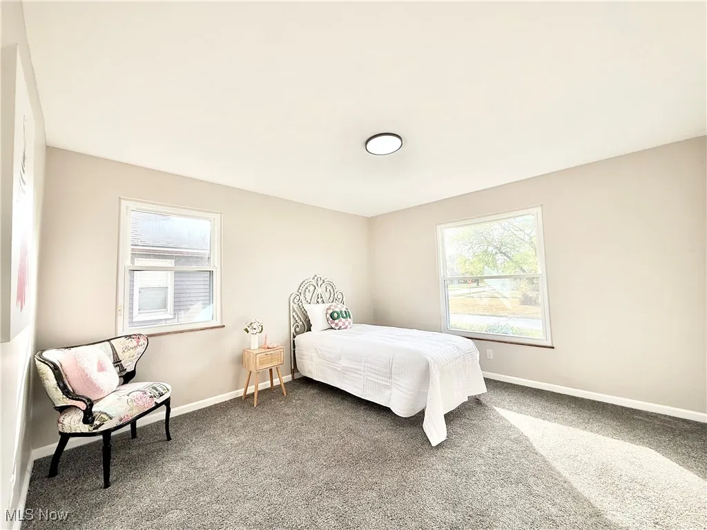 Bedroom featuring carpet floors and baseboards