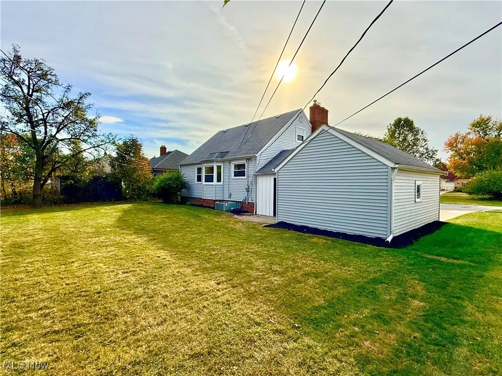 Rear view of house with a lawn