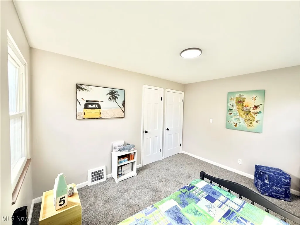 Game room with carpet flooring and baseboards