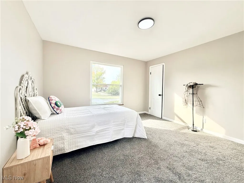 Bedroom featuring carpet flooring and baseboards