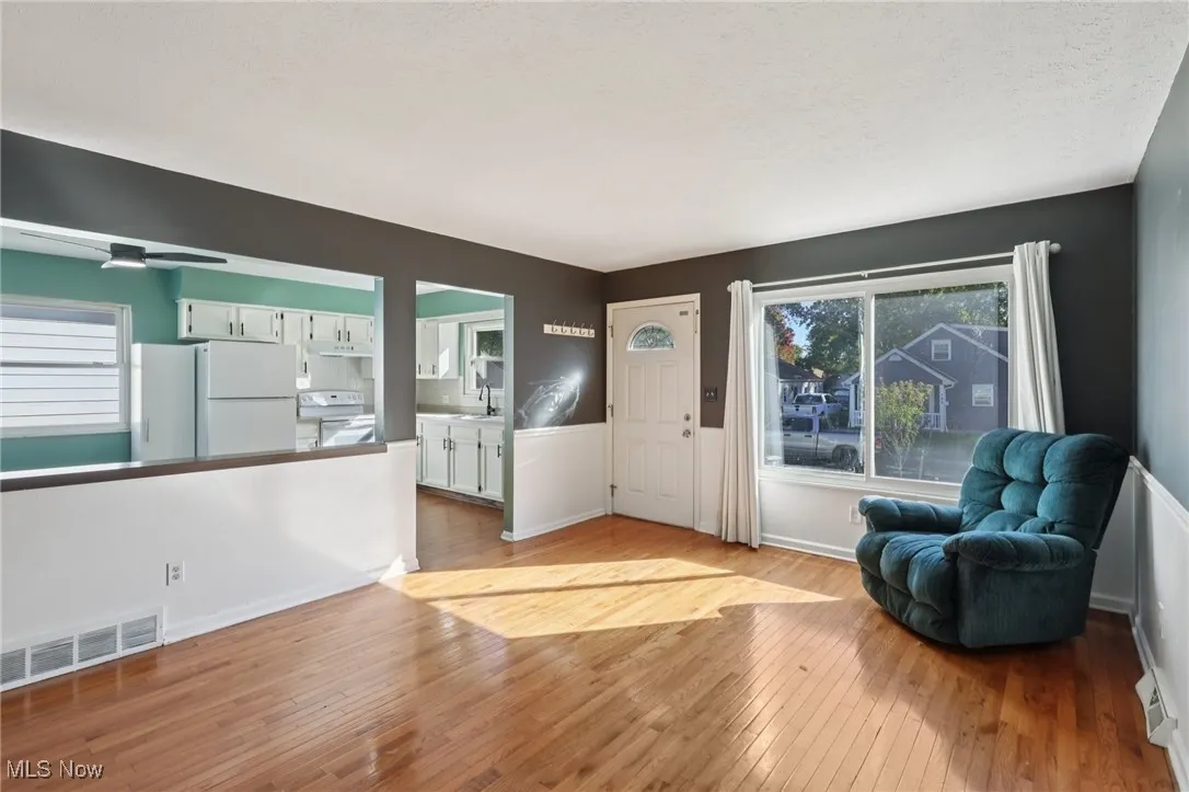 Entrance foyer with light wood-style floors and a textured ceiling