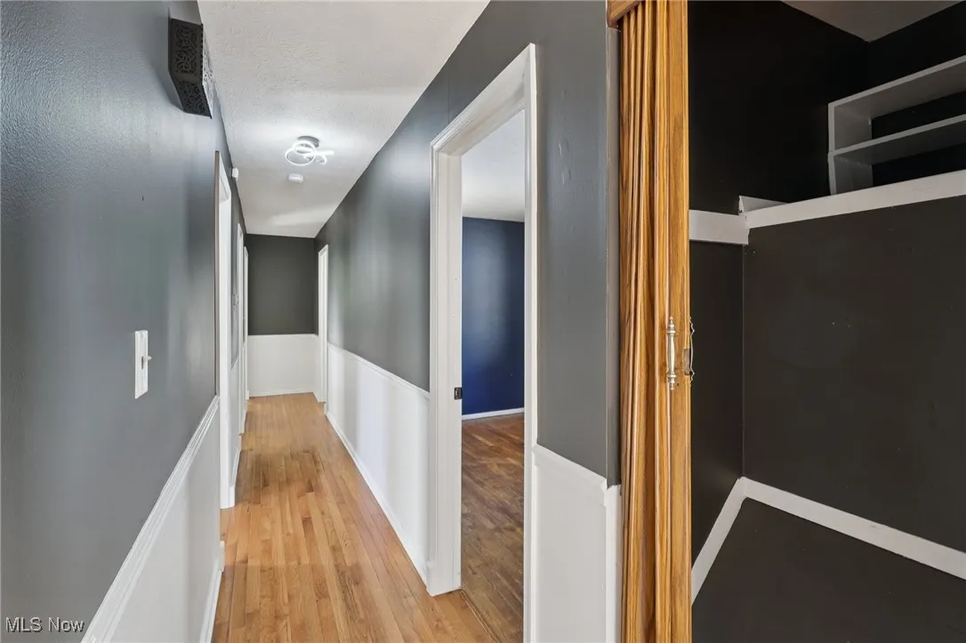 Hall with light wood finished floors