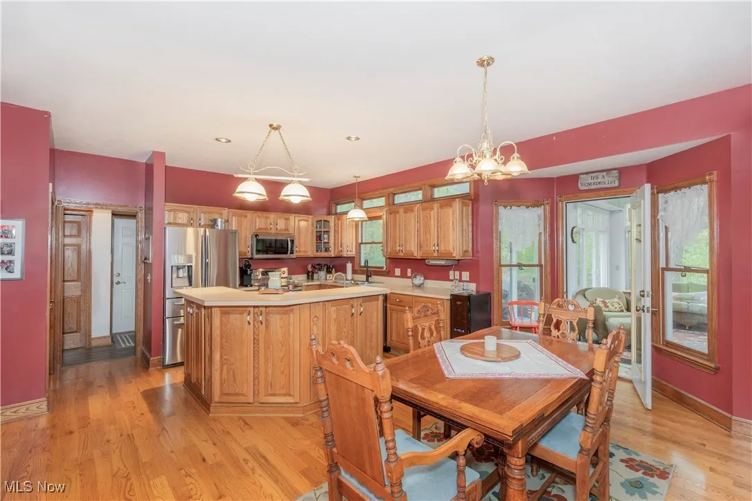 Spacious kitchen and eat-in dining space with wooden cabinetry and stainless steel appliances.