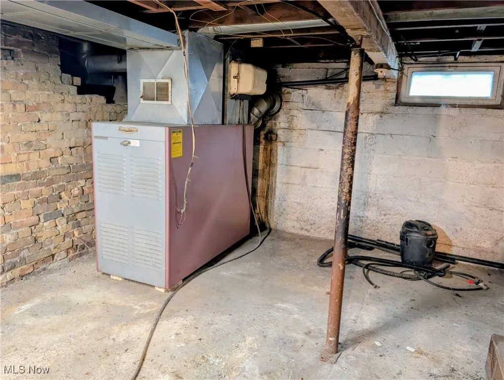 Basement featuring heating unit