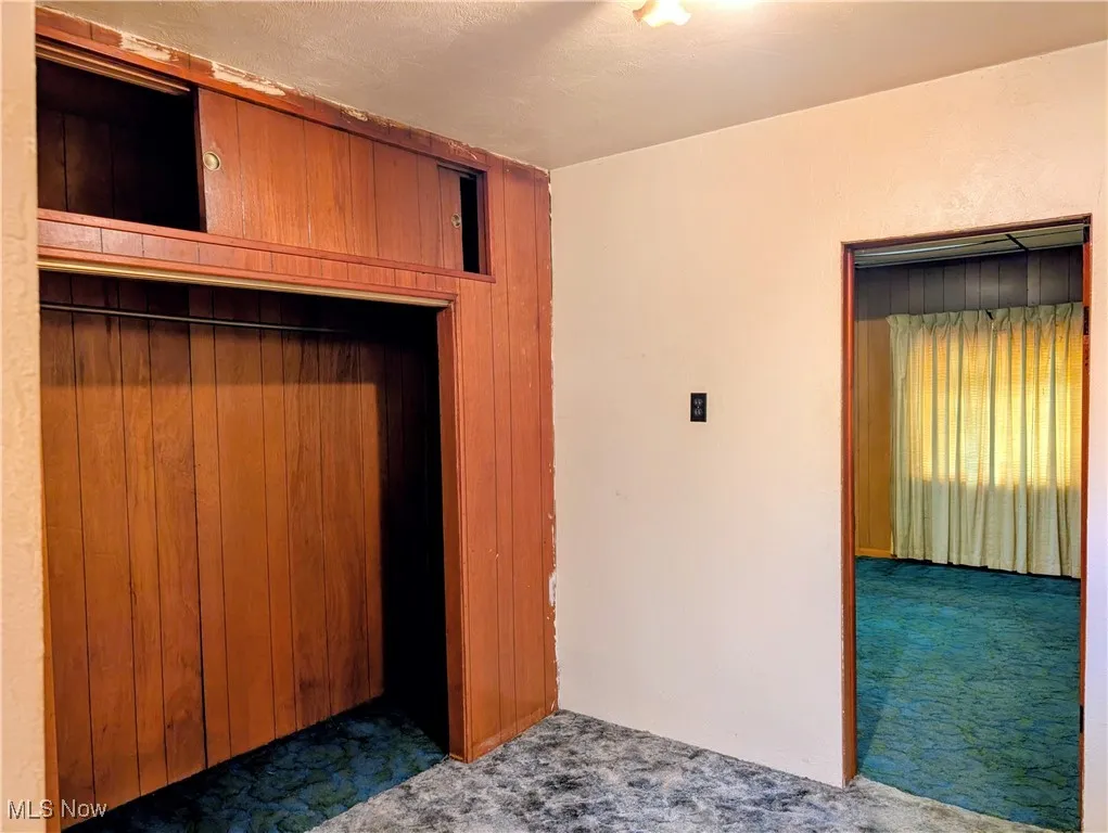 Unfurnished bedroom featuring carpet floors and a textured ceiling