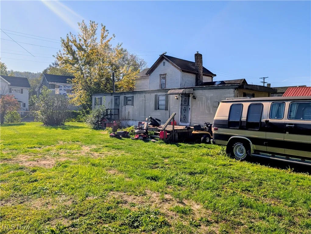 Rear view of property featuring a yard