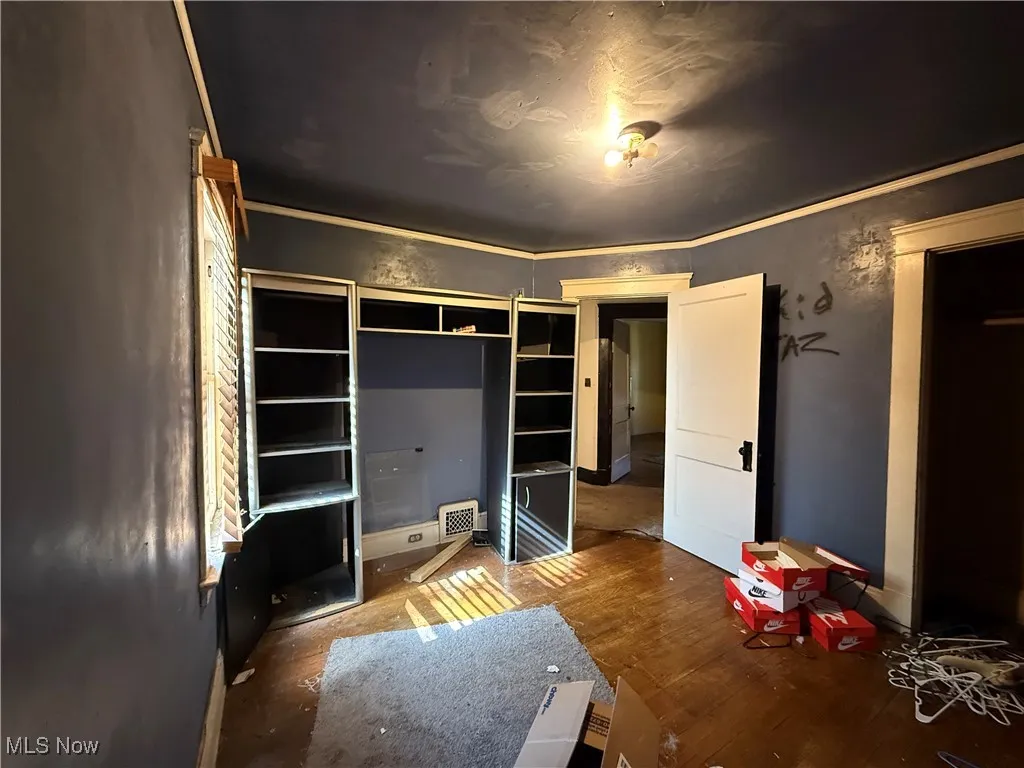 Unfurnished bedroom featuring wood finished floors