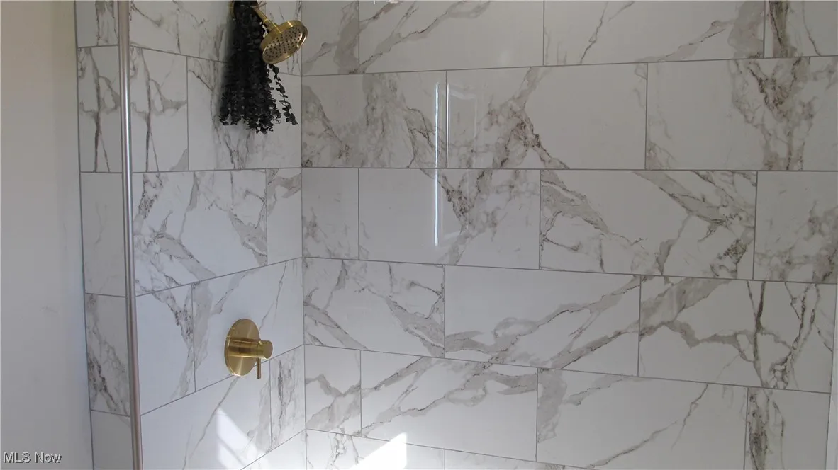 Bathroom view of a marble finish shower