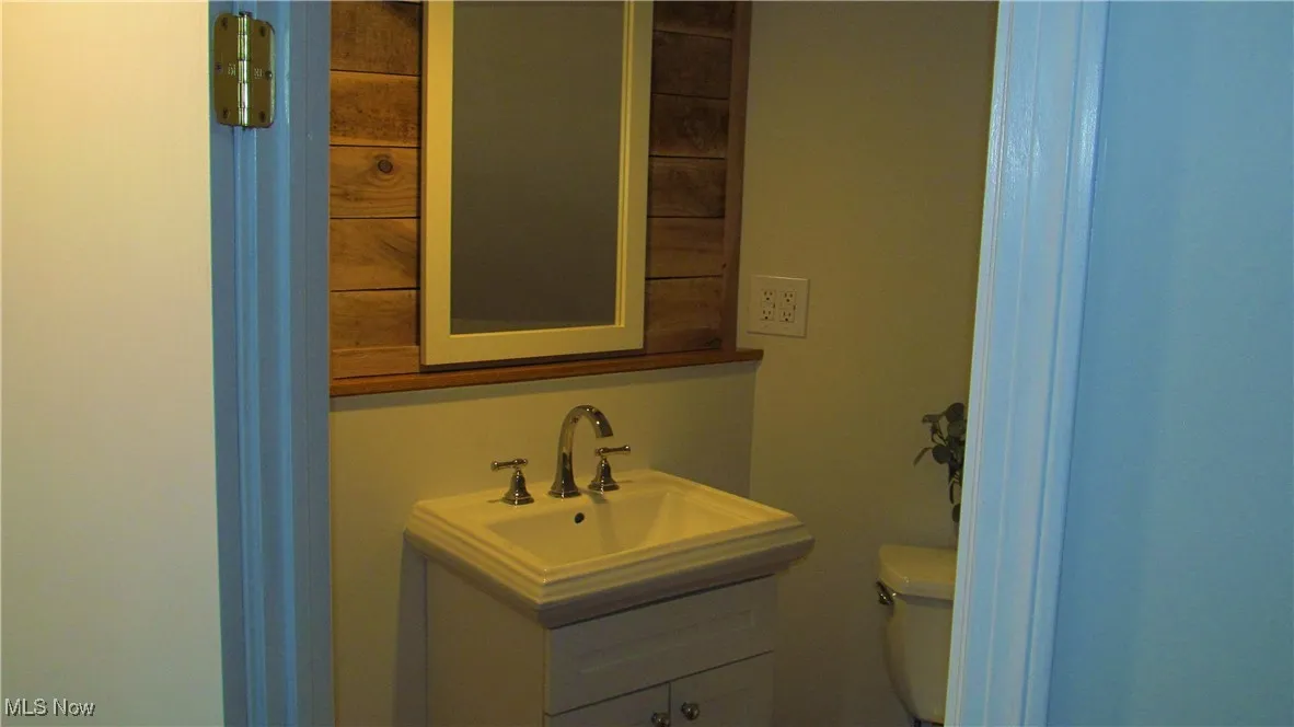 Half bath featuring vanity and toilet in 4th Bedroom