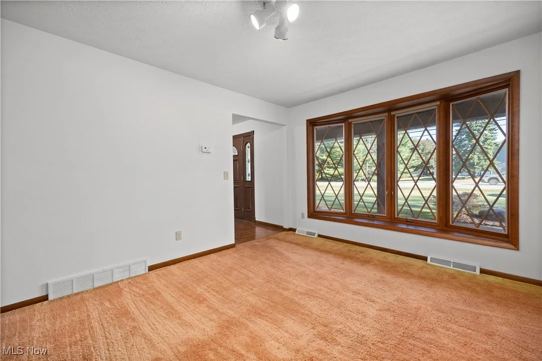 Spare room with carpet flooring and a textured ceiling