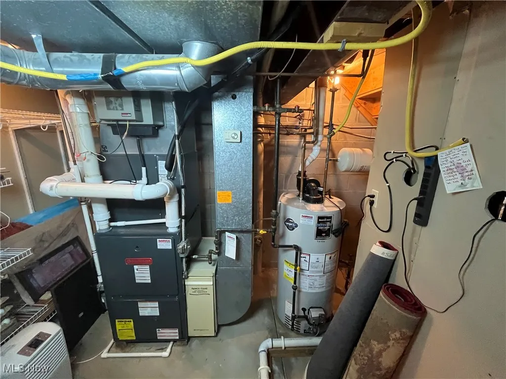Bradford White hot water tank with a space guard on the furnace covered by a home warranty