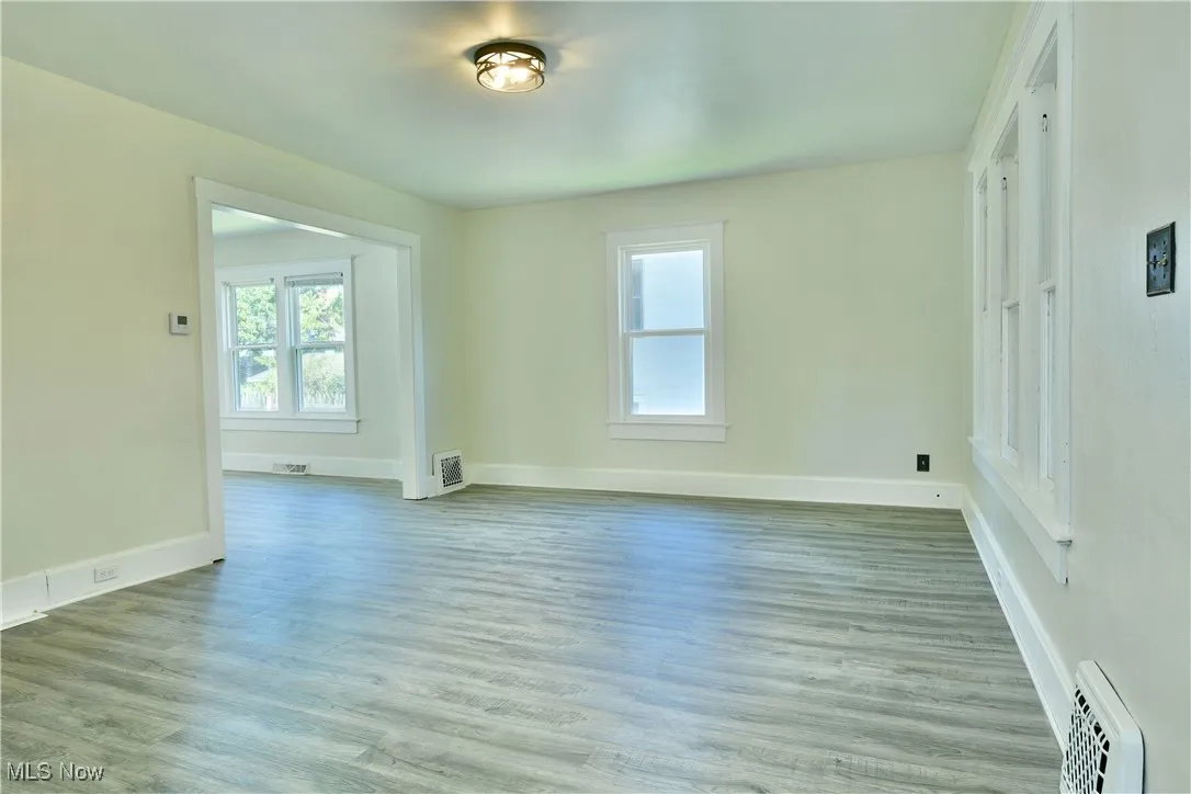 Empty room with wood finished floors and baseboards