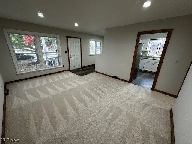 Spare room featuring recessed lighting and carpet
