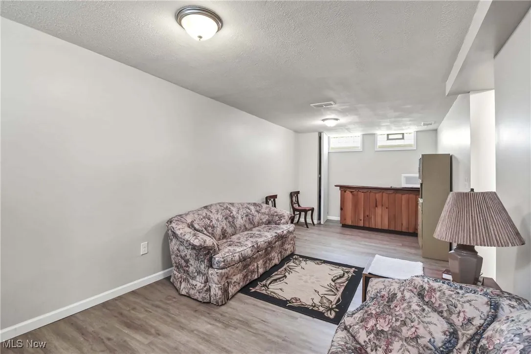 Living room featuring wood finished floors and a textured ceiling