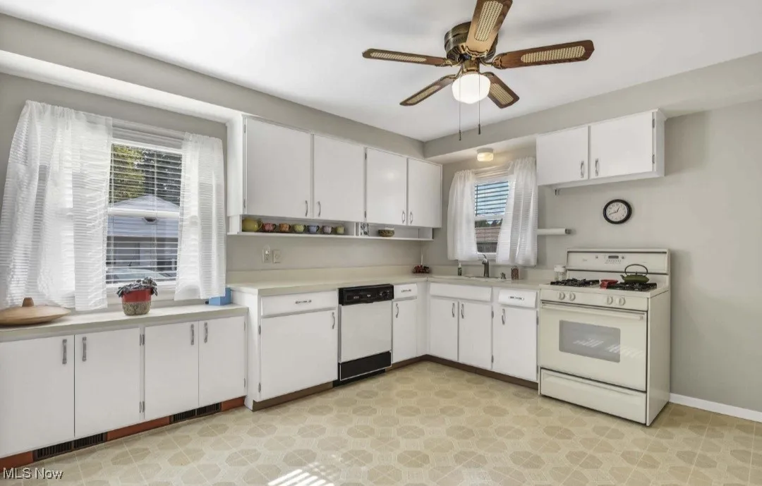 Kitchen with white appliances, light countertops, white cabinetry, open shelves, and a ceiling fan