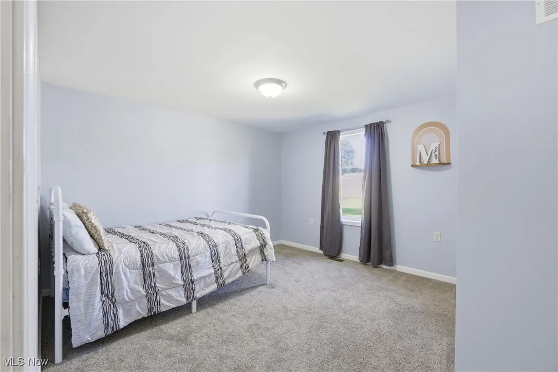 Carpeted bedroom with baseboards