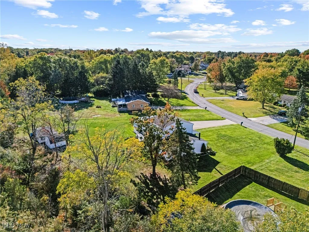 Aerial view of property's location with nearby suburban area