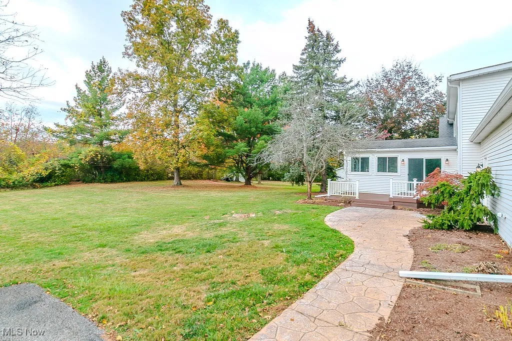 Spacious Backyard – Surrounded by mature trees and open space for outdoor fun.