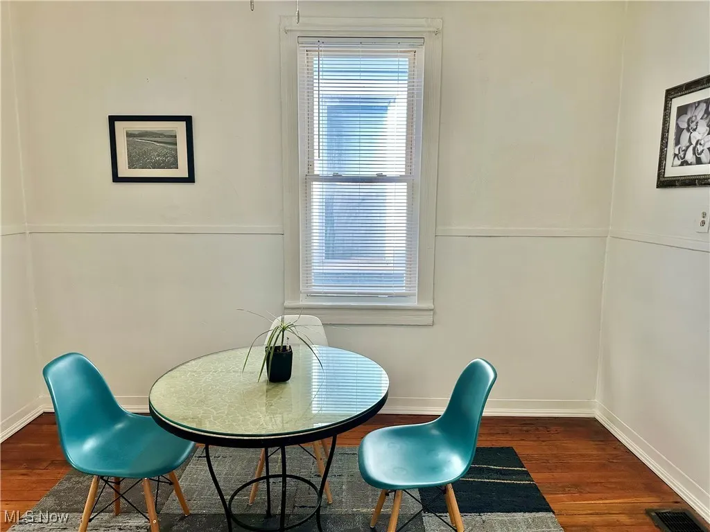 Dining room featuring dark wood-style floors