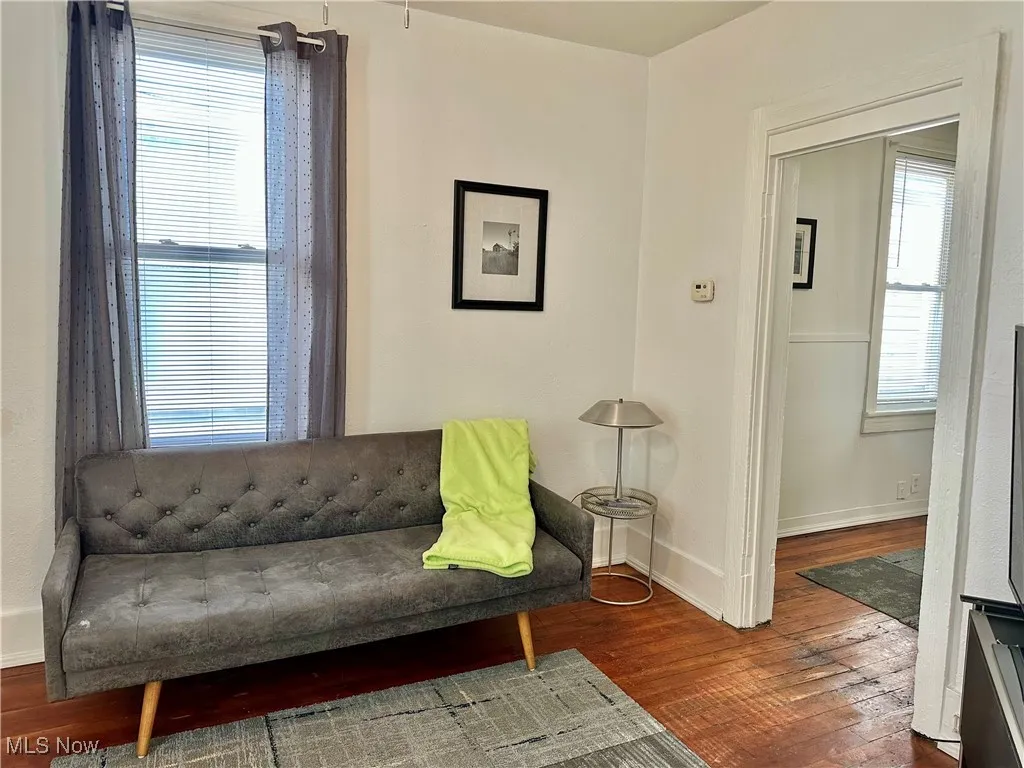 Living area featuring wood-type flooring and baseboards
