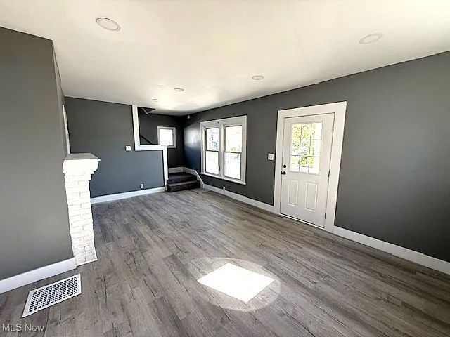 Entrance foyer featuring wood finished floors, stairway, and recessed lighting