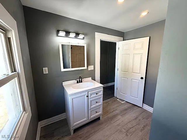 Bathroom featuring vanity, light wood-style flooring, and recessed lighting