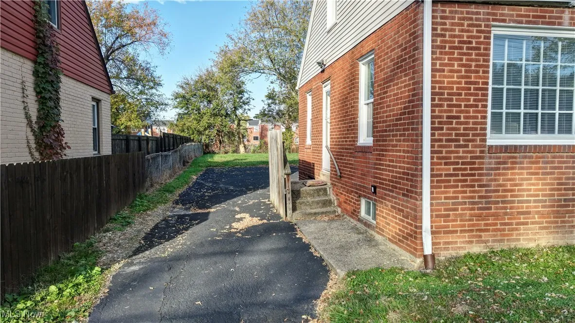 View of side of home featuring brick siding