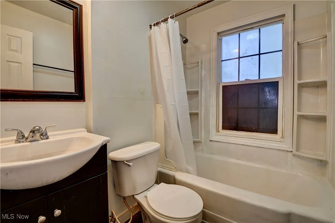 Full bath featuring shower / bath combo and vanity