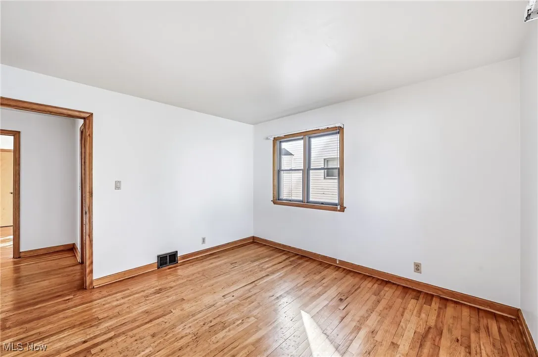 Spare room with light wood-style floors and baseboards