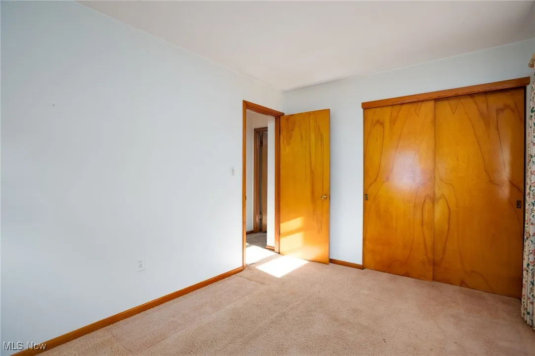 Unfurnished bedroom with a closet and carpet flooring