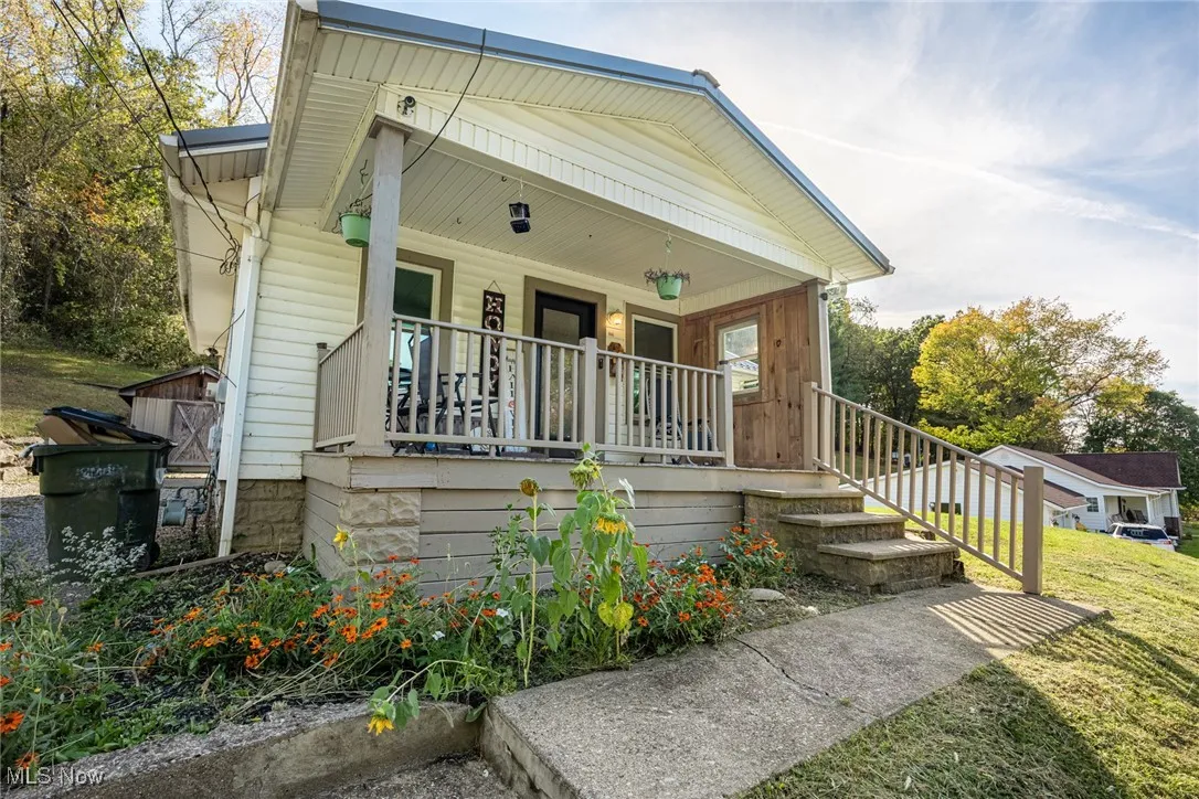 View of front of house with covered porch and a front yard