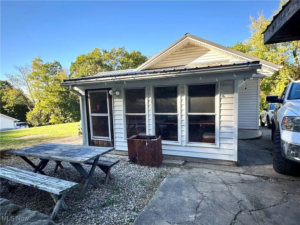 Back of house featuring a metal roof
