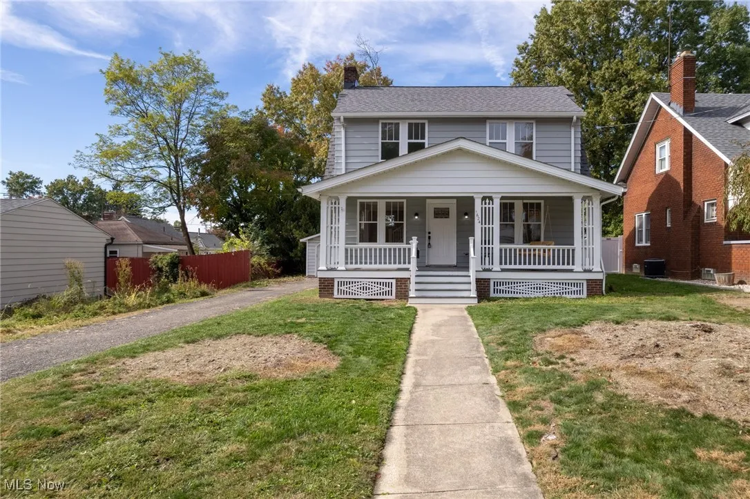View of front of house with covered porch and a chimney