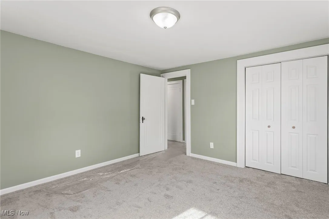 Unfurnished bedroom featuring carpet flooring and a closet