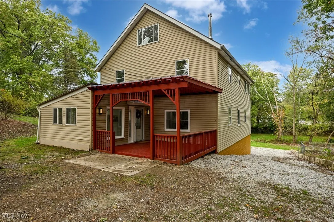 Rear view of house featuring a wooden deck