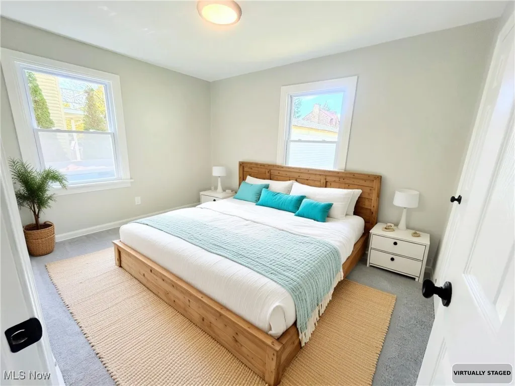 Bedroom featuring carpet flooring and multiple windows