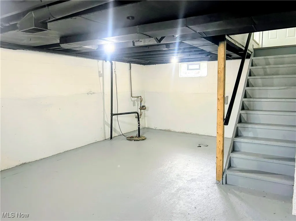 Below grade area featuring stairs and drainage system