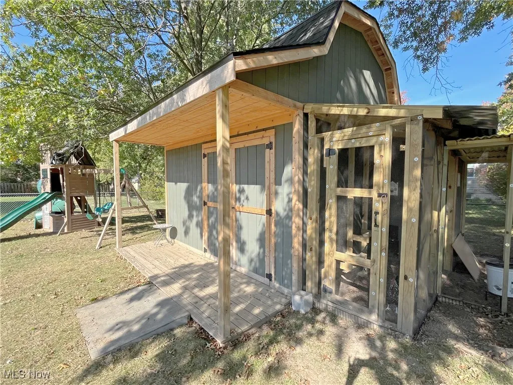 View of shed with a playground