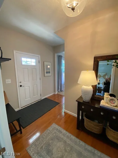 Foyer with wood finished floors and baseboards