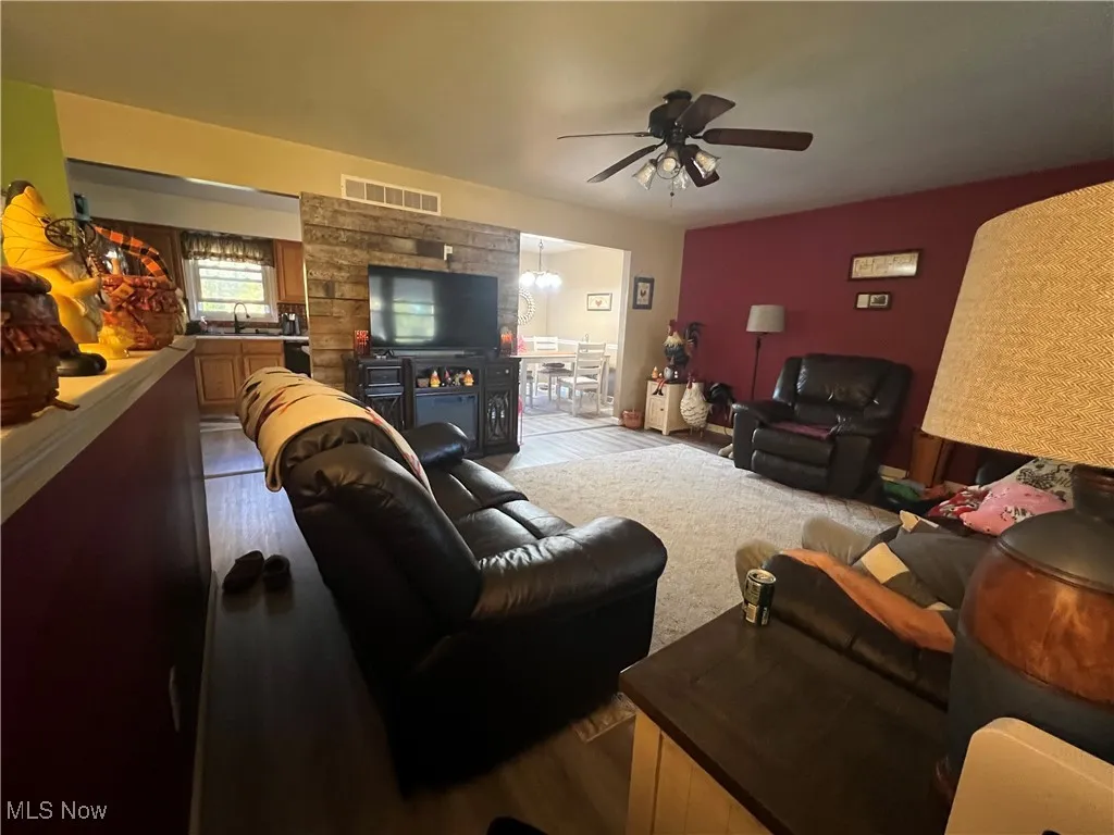 Living area with vinyl plank finished floors and ceiling fan